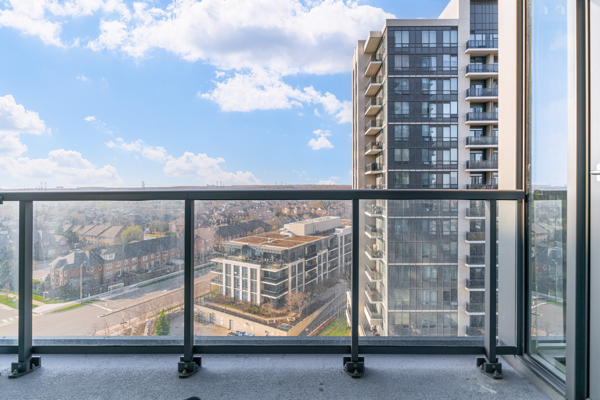 Balcony with glass railing and skyline view